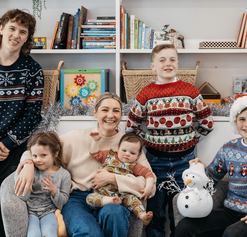 young people and parents in Christmas attire celebrating the holidays